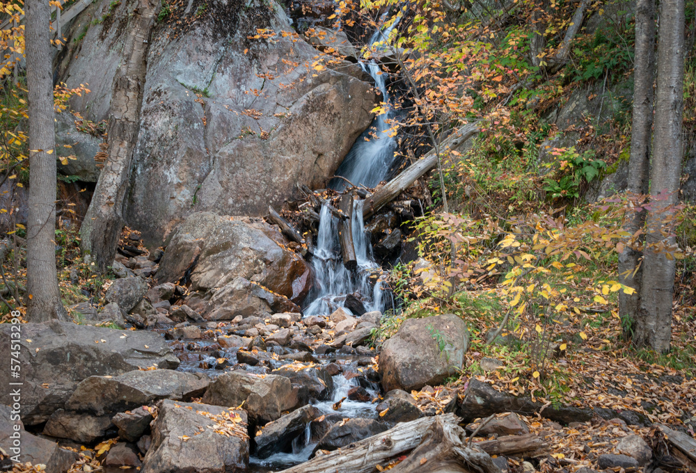 Obraz premium Waterfalls among autumn leaves on Mont Tremblant. Quebec. Canada.