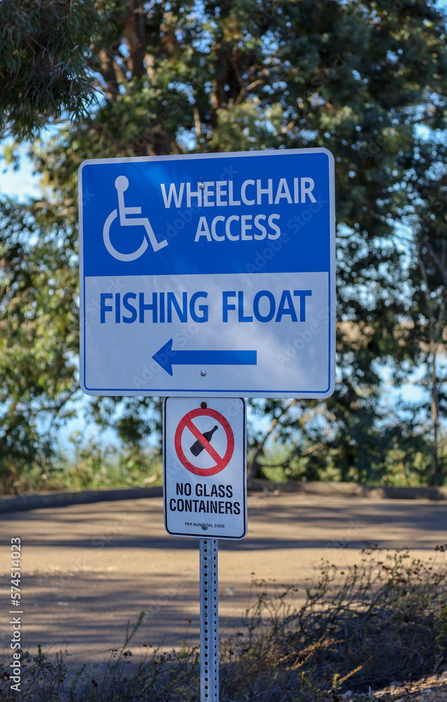 Wheelchair access fishing float and no glass containers signs o a post at Lake Miramar in San Diego, Ca.