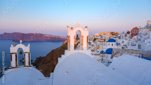 sunrise by the ocean of Oia Santorini Greece, a traditional Greek village in Santorini.  photo