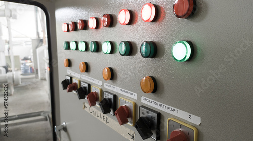 Foto Close-up of lit  lights and Control Switch on a industrial control chiller with shiny lights