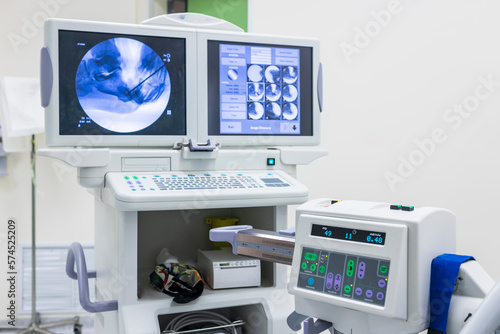 Fluoroscope medical device inside an orthopedic operating room in hospital.Xray used for diagnosis and help surgeon when doing surgery. Machine with monitor screen and copy space.Medical instruments. photo