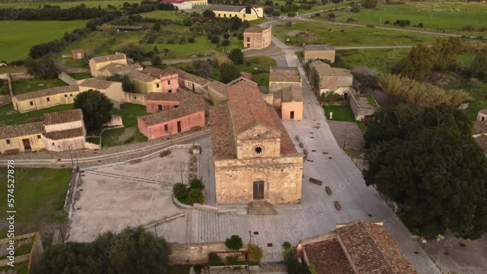 Establisher aerial view of Tratalias Church and square, Sardinia, lowering, day Establisher aerial view of Tratalias Church and square, Sardinia, lowering, day