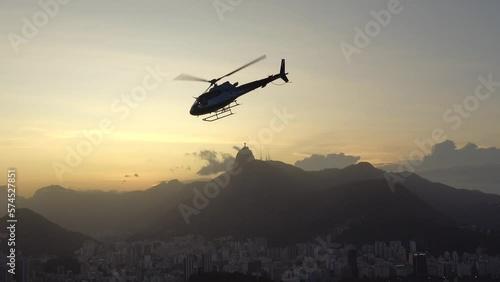 Helicopter flys past the Christ the Redeemer Statue in Rio de Janeiro, Brazil photo