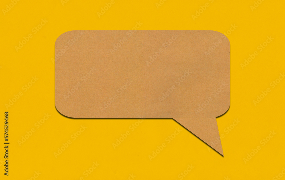 Brown paper speech bubble on yellow paper background. Brown paper speech bubble on yellow paper background.