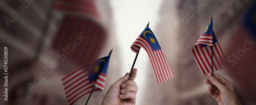 Photography A group of people holding small flags of the Malaysia in their hands