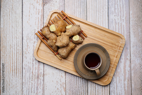 Ginger tea on wooden background.