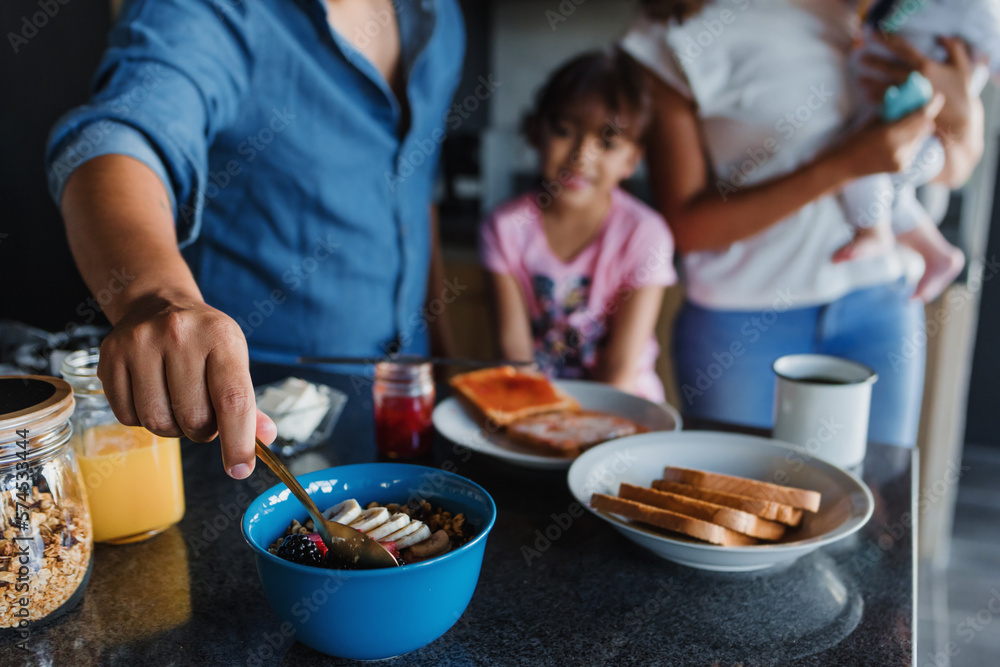 hand of father with child daughter preparing breakfast at kitchen in Mexico Latin America hand of father with child daughter preparing breakfast at kitchen in Mexico Latin America