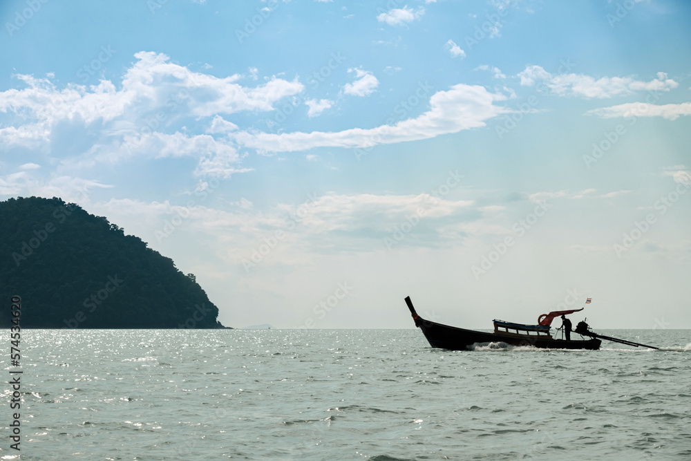 Traditional Longtail Boats with Mountains in the Andaman Sea, Seascape, Trang, Thailand. Traditional Longtail Boats with Mountains in the Andaman Sea, Seascape, Trang, Thailand.