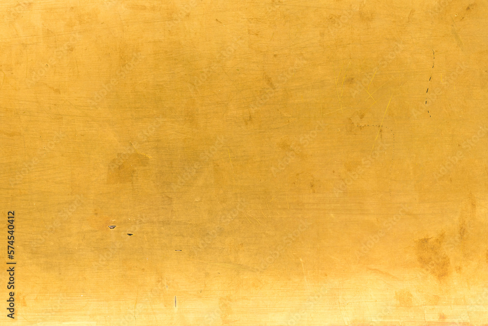 Artificial Gold background and texture on cement make from color paint for look like real gold. Gold foil leaf dirty abstract background texture distress scratch and gradients shadow in Gold glitter Artificial Gold background and texture on cement make from color paint for look like real gold. Gold foil leaf dirty abstract background texture distress scratch and gradients shadow in Gold glitter