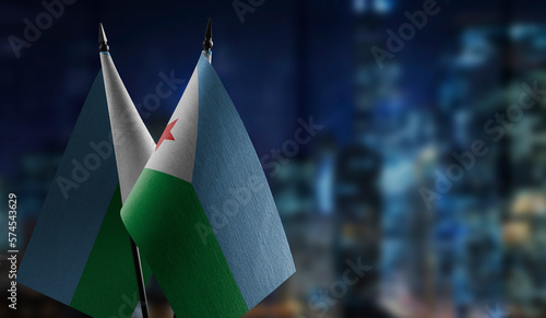 Small flags of the Djibouti on an abstract blurry background