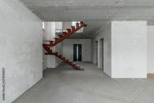 Repairs in the building. Building with a metal staircase at the time of renovation. Construction site in the house without people. Construction of a new house. Construction and architecture