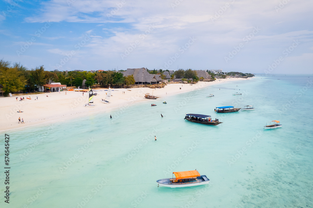 This drone shot of Nungwi Beach in Zanzibar captures the incredible beauty of the shoreline, with crystal-clear waters and golden sand providing a picture-perfect view.