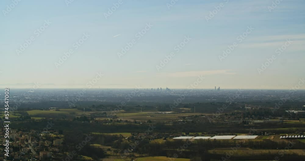 Milan from a great distance. Large city in a horizon. Expansion of civilization.