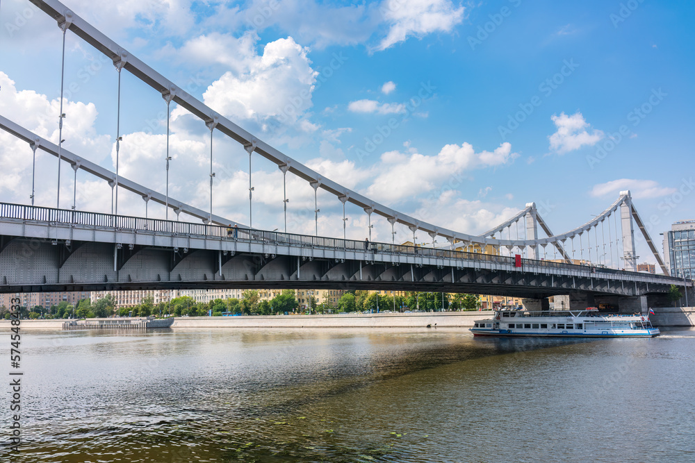 Krymsky Bridge or Crimean Bridge in Moscow and Cruise ship sails on the Moscow river Krymsky Bridge or Crimean Bridge in Moscow and Cruise ship sails on the Moscow river