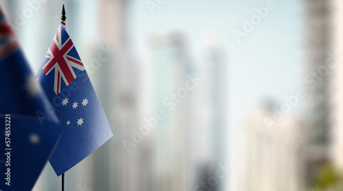 Small flags of the Australia on an abstract blurry background © butenkow