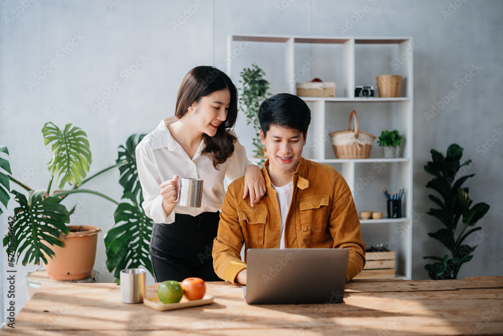 Portrait of success business people working together in home office. Couple teamwork startup concept. Portrait of success business people working together in home office. Couple teamwork startup concept.