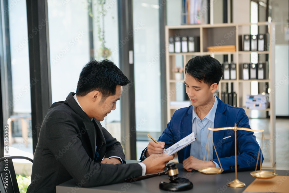 Asian business team and lawyers discussing contract papers sitting at the table. Concepts of law, advice, legal services. at office Asian business team and lawyers discussing contract papers sitting at the table. Concepts of law, advice, legal services. at office