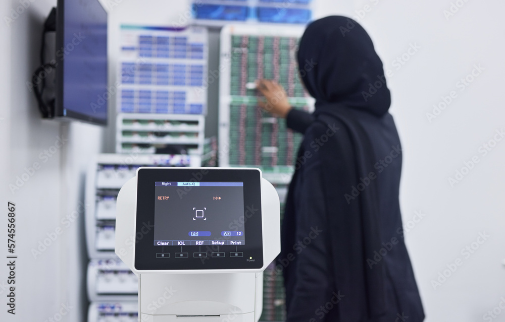 Optometry, screen for eye exam and Muslim optician with machine for vision test, eyesight and optical assessment. Healthcare, ophthalmology and optometrist working on medical camera for eyes scan Optometry, screen for eye exam and Muslim optician with machine for vision test, eyesight and optical assessment. Healthcare, ophthalmology and optometrist working on medical camera for eyes scan