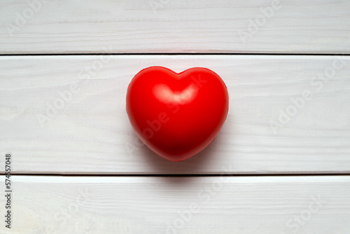A symbol of love on white wooden background 