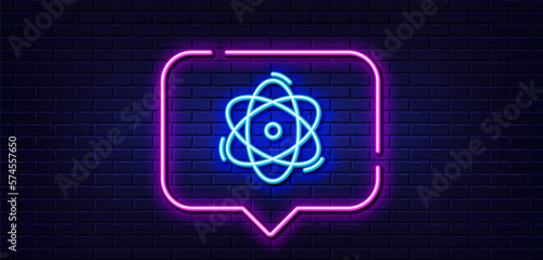 Neon light speech bubble. Atom line icon. Energy sign. Chemical element symbol. Neon light background. Atom glow line. Brick wall banner. Vector