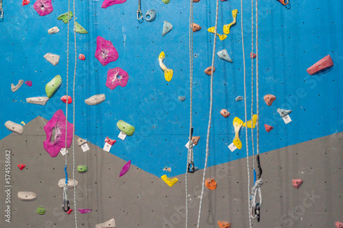 Multi-colored bright high walls of the climbing wall / Interior of a climbing wall for training climbers and climbers
