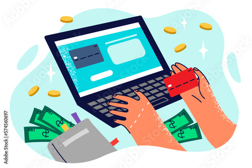 Hands of person doing online shopping through laptop entering credit card details to make payment