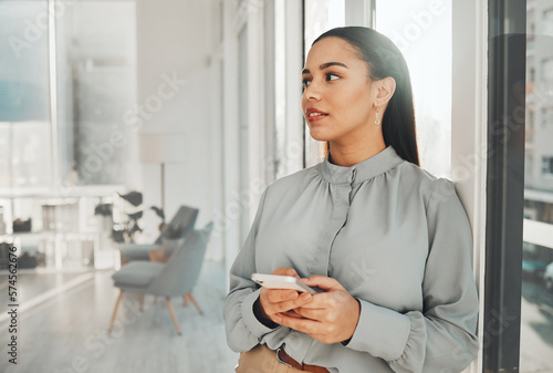 Business woman, thinking and phone in a corporate law firm with lawyer ideas for work. Modern office, Indian female and mobile of a employee with workplace vision and digital transformation ideas