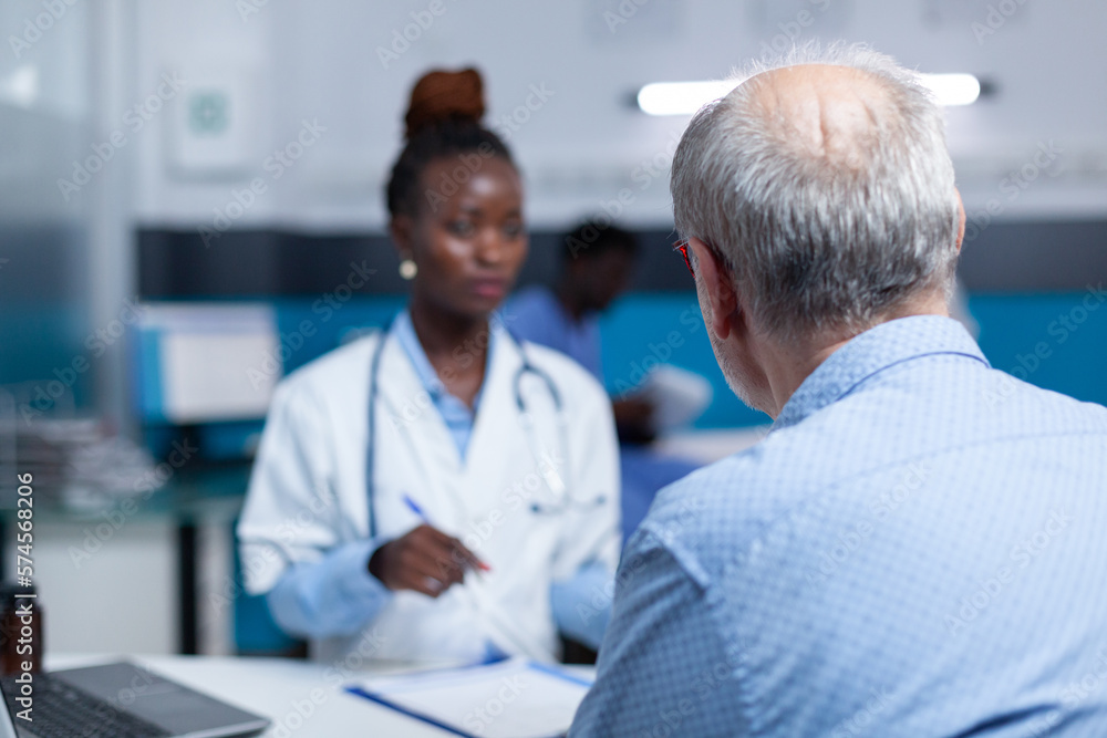 Clinic general practitioner expert talking to retired patient about health risks and treatment benefits. Hospital medic specialist speaking about consultation appointment, prescribed medicine and Clinic general practitioner expert talking to retired patient about health risks and treatment benefits. Hospital medic specialist speaking about consultation appointment, prescribed medicine and
