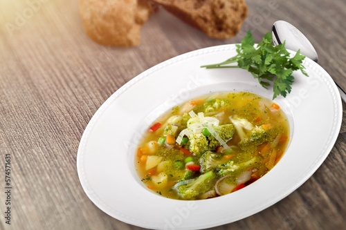 Tasty fresh soup dish in plate with bread