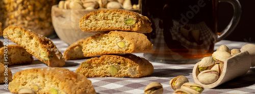 Biscotti Cantuccini Cookie Biscuits with pistachios and lemon peel Shortbread. Cup of tea. Teatime break Healthy eating food. Homemade fresh Italian cookies cantucci stacks and organic pistachios nuts photo
