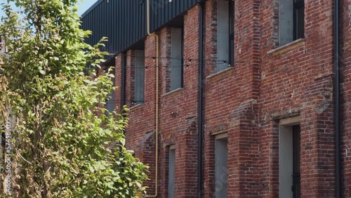 Lviv / Ukraine - 06/05/2022: Old factory buildings renovated to business hub. Old plant rebuilt in loft style. Red brick factory shops with cafes, offices and public 
