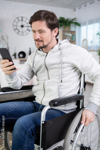 disabled man in the home looking at smartphone