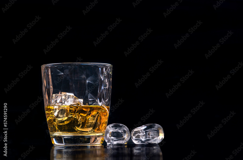 Whisky glass with ice on black background Whisky glass with ice on black background