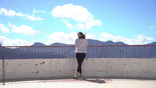 Woman looking at mountains landscape at viewpoint in Artenara, Gran Canaria, Spain. photo