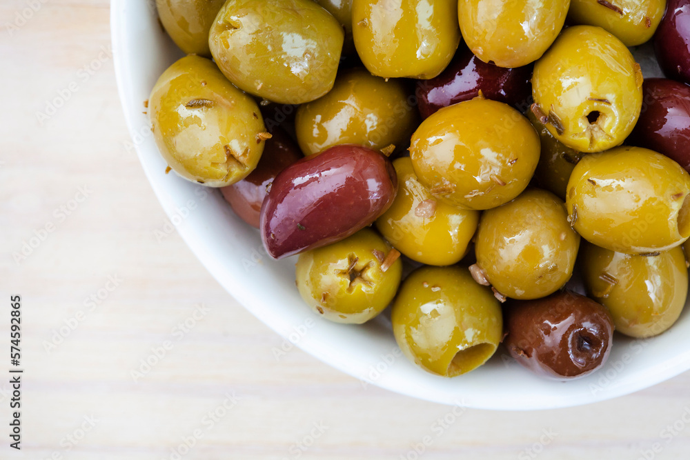 Mixed marinated olives on light wooden surface with copy space Mixed marinated olives on light wooden surface with copy space