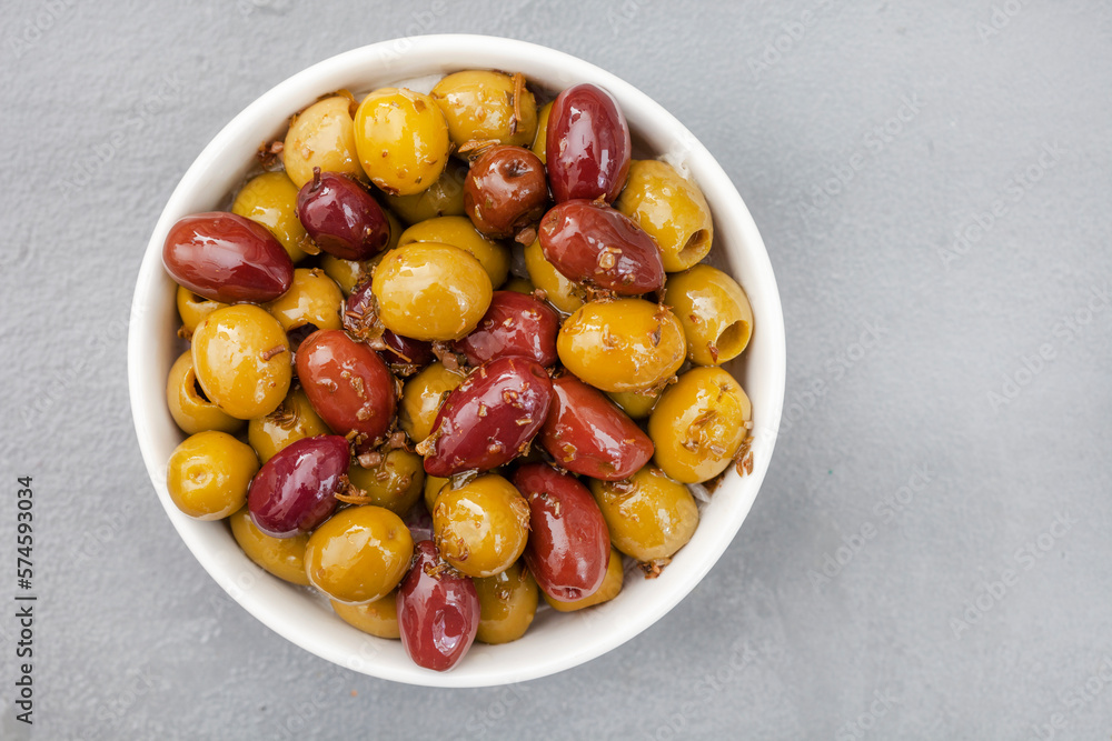Mixed marinated olives on grey surface with copy space Mixed marinated olives on grey surface with copy space