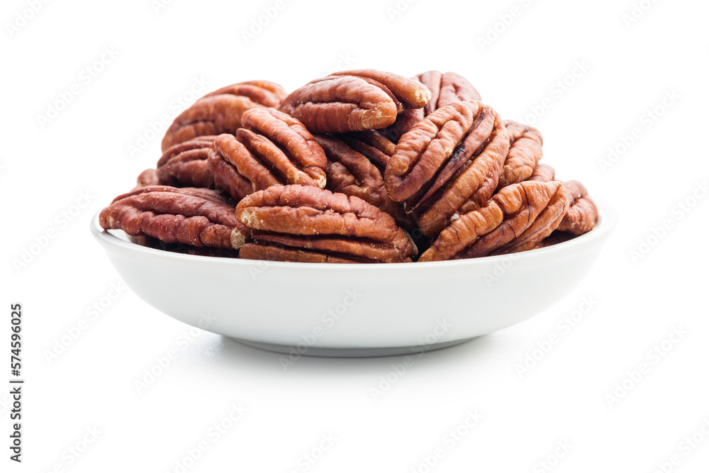 Peeled pecan nuts in bowl isolated on white background. Peeled pecan nuts in bowl isolated on white background.