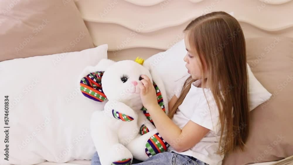 A small child happily plays with a soft toy A small child happily plays with a soft toy