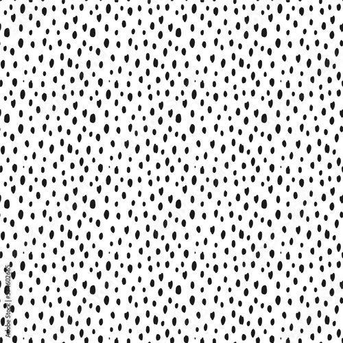 Seamless speckled pattern with black hand drawn dots on white background. Polka dot, black on white. Vector illustration.