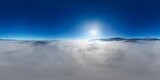 360 panorama aerial drone view above the sea of clouds and surrounded by mountains with a deep blue sky and a beautiful radiant sun, a fairy tale-like dreamy cotton bed at altitude