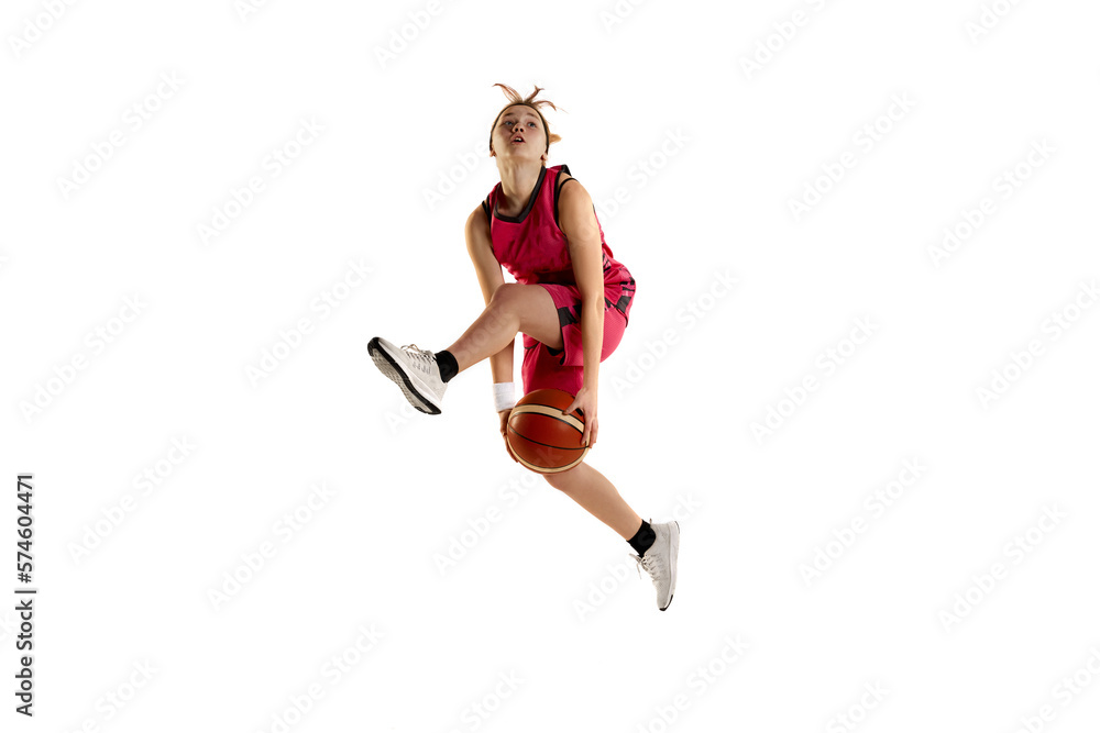 Jump shot. Teen girl, basketball player in action, jumping with ball isolated over white studio background. Concept of sportive lifestyle, active hobby, health, endurance, competition. Ad