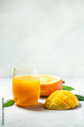 Tasty mango drink and fresh fruits on a light background. vertical image. top view. place for text