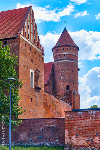 Olsztyn, Poland, August 10, 2022. Castle of Warmian Chapter, photo from north, northwest pediment and lavatory. castle was erected in naturally defensive place, on hill in wide bend of Lyna River.