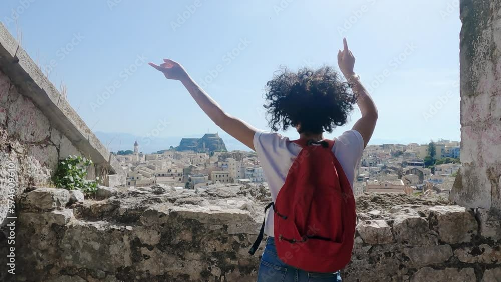 custom made wallpaper toronto digitalPositive tourist woman dancing and jumping visiting a new venetian fortress in Corfu, Greece with amazing panoramic aerial view of Kerkira landmarks, slow motion