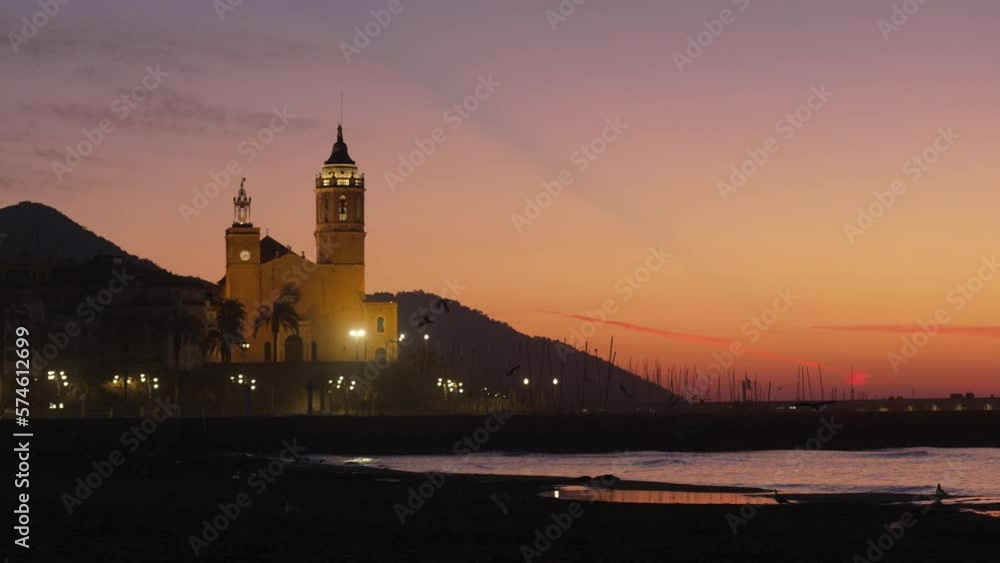 Red sunset twilight coast with a church silhouette of hills and birds flying Red sunset twilight coast with a church silhouette of hills and birds flying