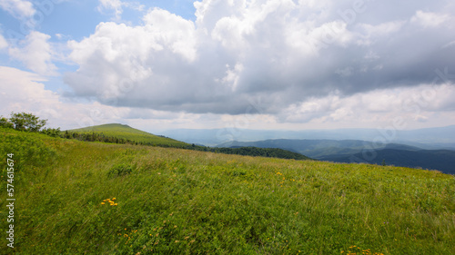 nature scenery with hills and meadows. summer mountain landscape with clouds on the sky