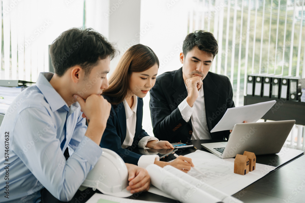 Creative architect projecting on the big drawings in the dark loft office or . Creative architect projecting on the big drawings in the dark loft office or .