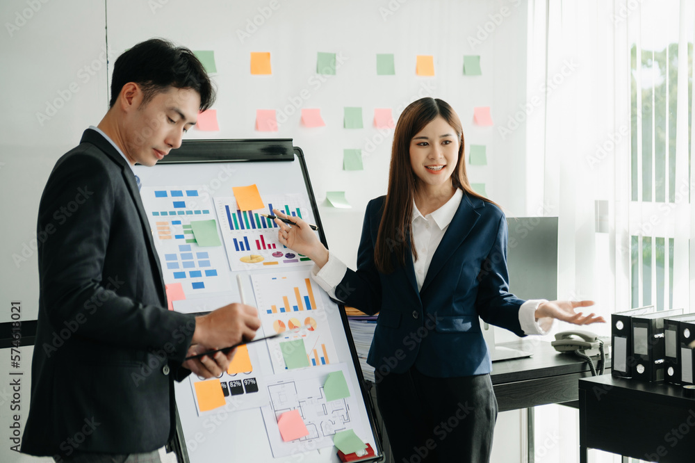 The boss stands near the board with graphs, demonstrates statistics, various personnel attending the training, introduces the new products of the company, in office. The boss stands near the board with graphs, demonstrates statistics, various personnel attending the training, introduces the new products of the company, in office.