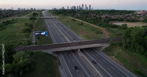 Flying in over train tracks highway skyline photo