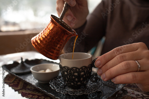 Fototapeta Naklejka Na Ścianę i Meble -  Close-up of hands hold the cup of turkish coffee